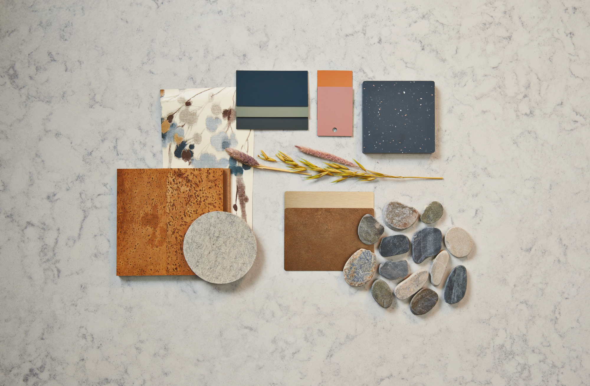 Design palette featuring blue, brown, orange and cream colored samples of fabric, tile and woodgrains from Formica Group and FENIX Innovative Materials