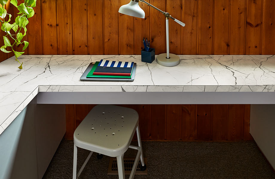 Bureau de coin en stratifié de marbre blanc avec cahiers de notes, lampe et tabourets en métal