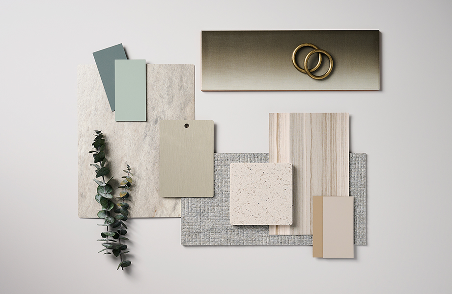 Échantillons rectangulaires de surfaces vertes, bronze, métalliques et crème, et un bout de plante verte séchée dans un agencement de palette de designer